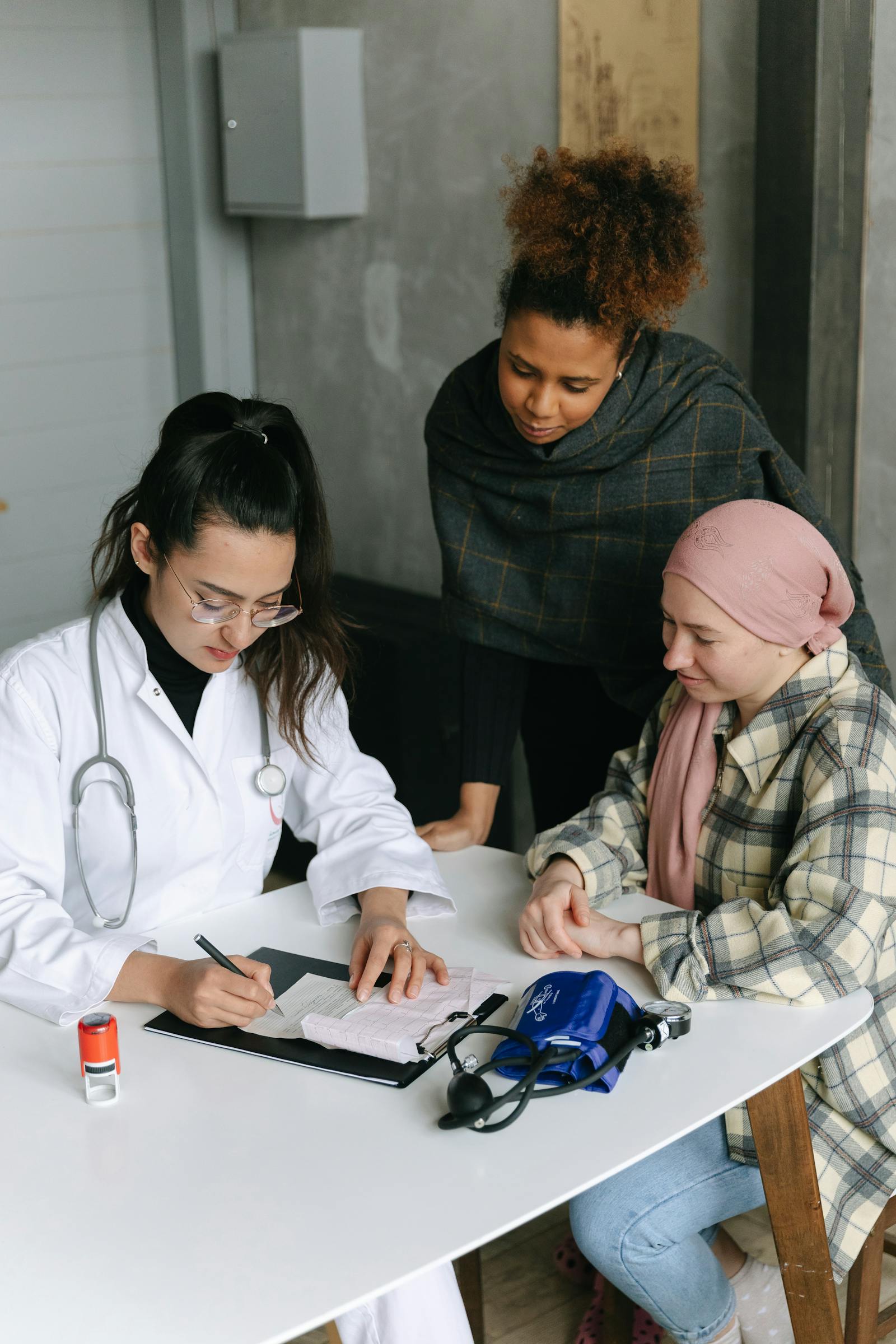 A clinician taking case notes alongside a patient